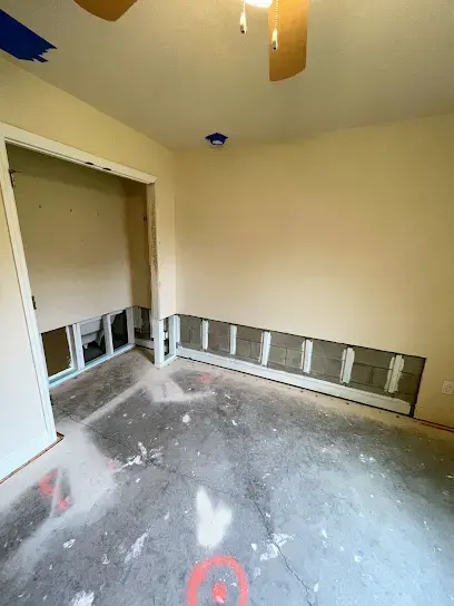 Drywall cut along the base of the walls during a dry-out north of Tampa