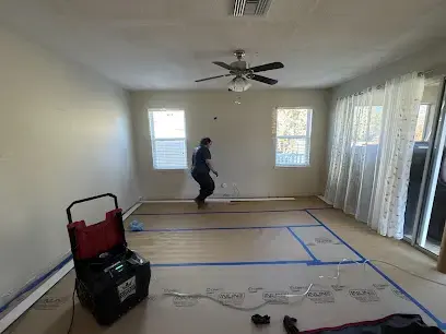 Floor protected and a dehumidifier running during a water damage dry-out in Lutz