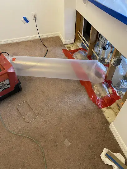 Drying hose pushing air under kitchen cabinets after an appliance leak