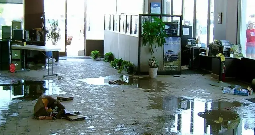Standing water across the floor of a flooded office