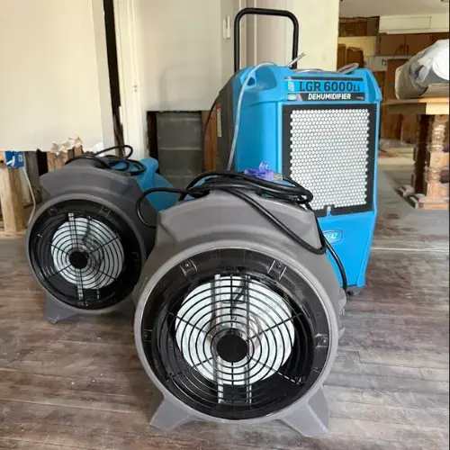 Air movers and an LGR dehumidifier set up for structural drying in Lutz, FL